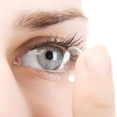 Woman trying to wear contact lens