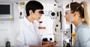optometrist performing comprehensive eye exam